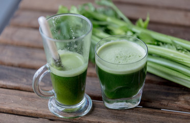 Two glasses of celery juice on a table