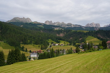 Fototapeta na wymiar Soraga, little village in Val di Fassa, Trentino, italian Dolomites, Italy. View of Catinaccio range