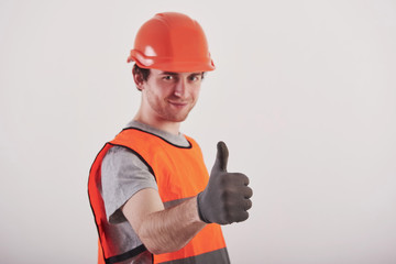 No troubles, I'll make everything perfect. Man in orange colored uniform stands against white background in the studio