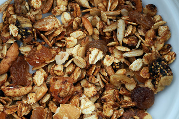 Healthy breakfast texture background. Grain breakfast ingredients on a plate. View from above, horizontal, close-up. Healthy food concept.