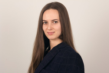 Obraz premium Portrait of a beautiful girl on a light background, close-up