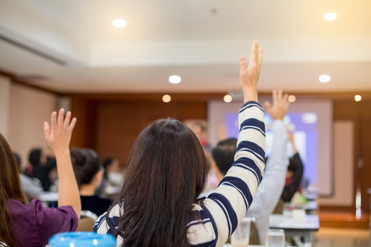 Business People Raise Their Hands To Vote For Shareholders' Meeting Or Seminar Event In The Meeting Room. Participants Are Raising Their Hands To Ask Questions.