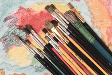 Vintage brushes on painting background