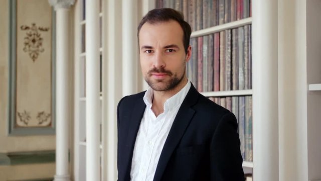 Portrait of handsome young man standing in museum