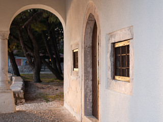 wooden entrance of a little church in Cres