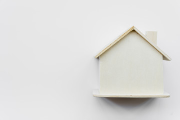 Fototapeta na wymiar Simple miniature wooden house against white background