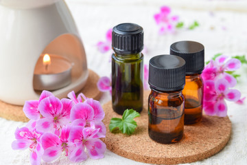 Fototapeta na wymiar essential oils with rose geranium flower at spa salon
