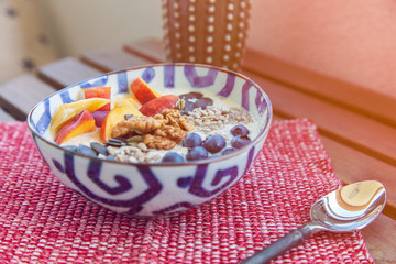 Oatmeal porridge with fresh fruit and cranberries. Healthy breakfast. 