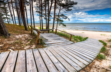 Pine forest, wooden footpath and a shore of the Baltic Sea, concept of clean and ecologically friendly tourism in Europe