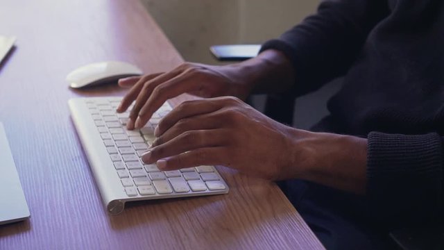 Businessman's hand typing on wireless keyboard