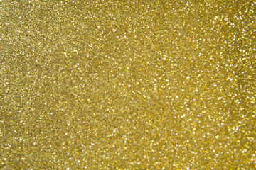 Abstract blurred background of golden glitter light.