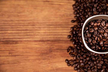 coffee beans mug and wood background.