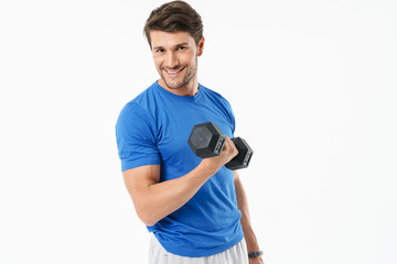 Full length photo of handsome sportsman in shorts and t-shirt lifting weight while doing workout