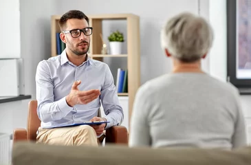 Poster geriatric psychology, mental therapy and old age concept - psychologist talking to senior woman patient at psychotherapy session © Syda Productions