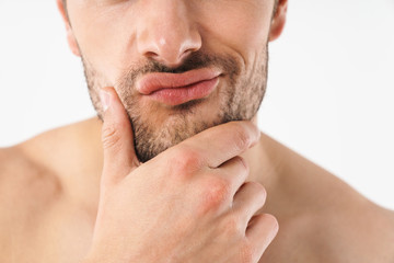 Obraz premium Cropped photo closeup of caucasian naked man touching his chin and making displeased face with twisted lips