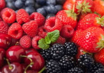 Fresh organic summer berries mix. Raspberries, strawberries, blueberries, blackberries and cherries. Macro. Close up