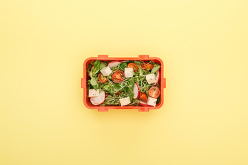 top view of lunch box with salad and vegetables