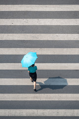 Chengdu, Sichuan province, China - June 12, 2019 : Young chinese woman with an umbrella walking on...