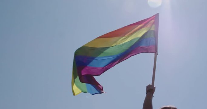Pride LGBT rainbow flag waving in slow motion during a pride parade