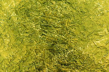  The stucco texture of the wall is painted in golden green for the background.