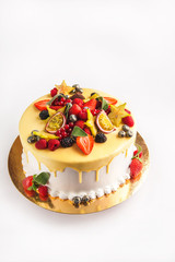 Cake with fruit, chocolate, flowers is isolated on a white background close-up and copy space.