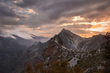  Natural landscape in winter with mountains and forest at sunset.