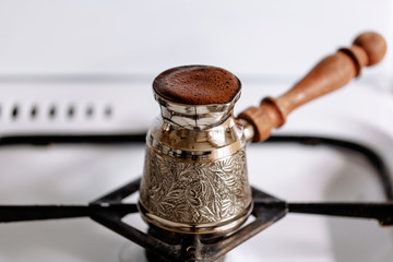 Real coffee brewed in a coffee pot on a gas stove