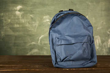 Blue backpack on wooden table