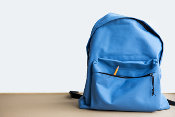 Blue schoolbag with pencil in pocket