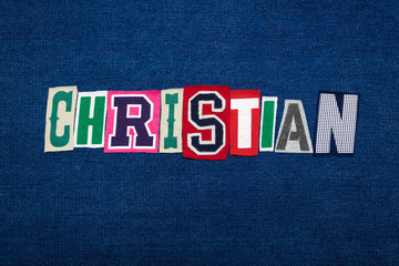 CHRISTIAN collage of word text, multi colored fabric on blue denim, Christianity religion diversity concept, horizontal aspect