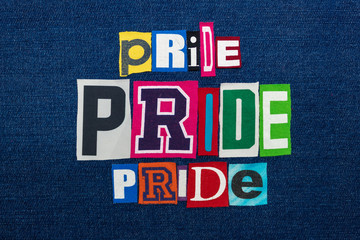 PRIDE PRIDE PRIDE collage of word text, multi colored fabric on blue denim, LGBTQ inclusion concept, horizontal aspect