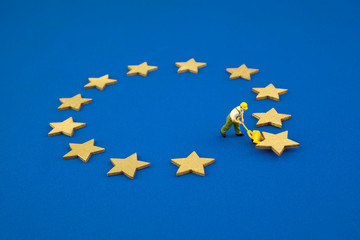 Brexit concept. The figure pushes one star out of the Europen Union Flag