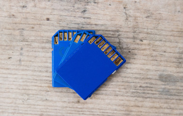 blue flash memory SD card on a wooden board