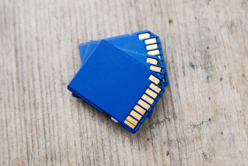 blue flash memory SD card on a wooden board