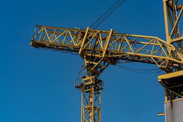 detail of yellow dockside crane at the industrial harbour in Rostock