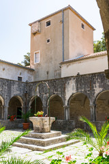 Fototapeta na wymiar gallery and patio with wishing well of monastery on Kosljun Island, near Krk. Croatia
