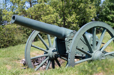 Old metal cannon. Shipka, Gabrovo, Bulgaria. The Shipka Memorial is situated on the peak of Shipka in the Balkan Mountains near Kazanlak, Bulgaria. Old metal cannons against blue sky with clouds.