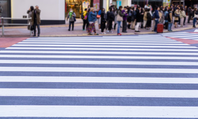 People walking across the crosswalk.