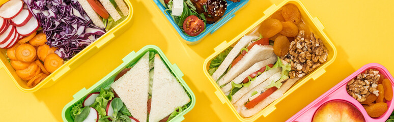 panoramic shot of lunch boxes with food