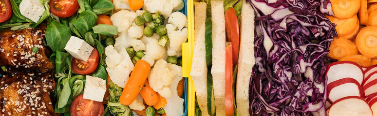 panoramic shot of lunch boxes with food