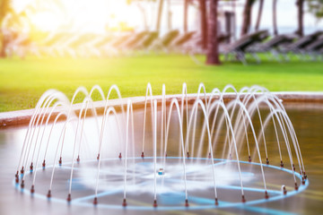 A beautiful fountain for soothing and relaxing in a hotel in Thailand. sunny background, green plants.