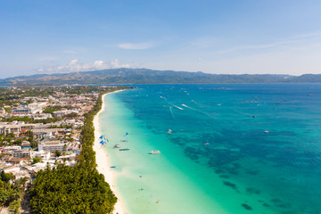 Island Boracay, Philippines, view from above. White beach with palm trees and turquoise lagoon with...