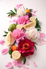 Obraz na płótnie Canvas Creative layout made of various citrus fruits, plants, leaves and flowers decoration. Colorful Summer food and health concept. Flat lay, top view