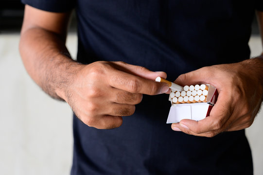 Close up of male hand take a pack of cigarette. Stop smoking concept
