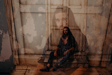Fototapeta premium Double exposure. Enlightened cute man with a dreadlocks on his head and a beard in art scene