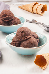 Chocolate ice cream bowls on the wooden surface. - 276556292