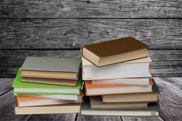 Ancient books in a row on wooden background