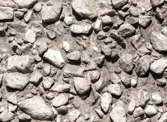 Stone rubble in the concrete wall as background