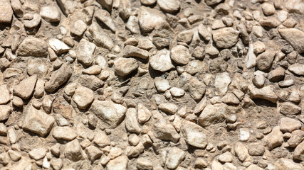 Stone rubble in the concrete wall as background