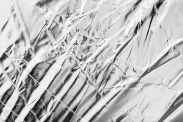 Crumpled silver material as abstract background
